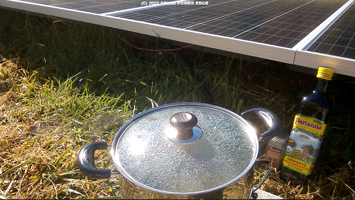 Early test of PV2L solar electric camp stove cooking chicken in a stainless steel pot off of direct DC solar power